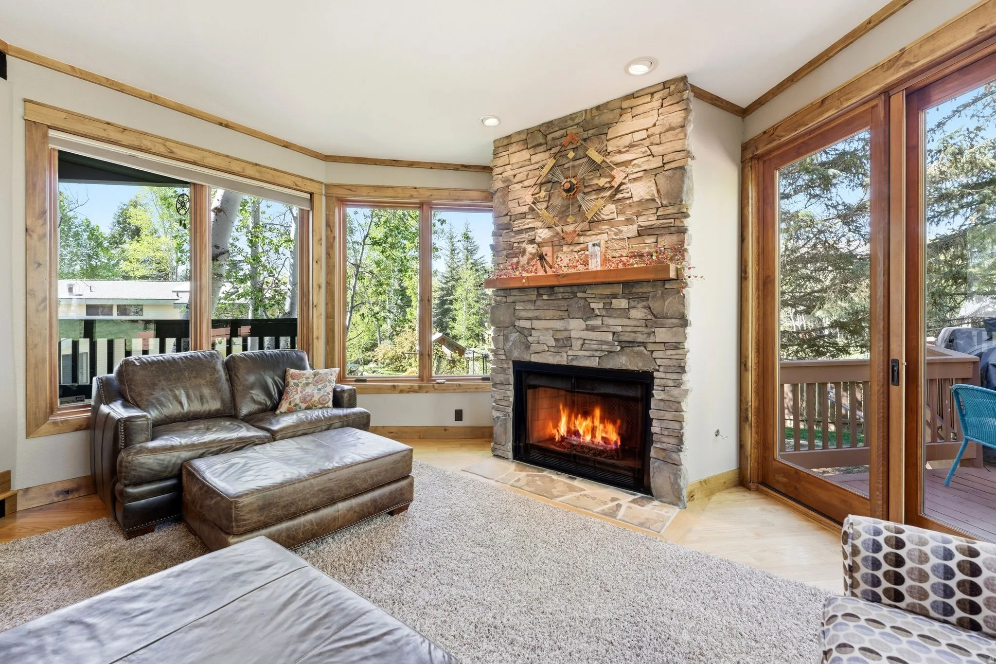 Stone-clad fireplace with a natural wood mantel