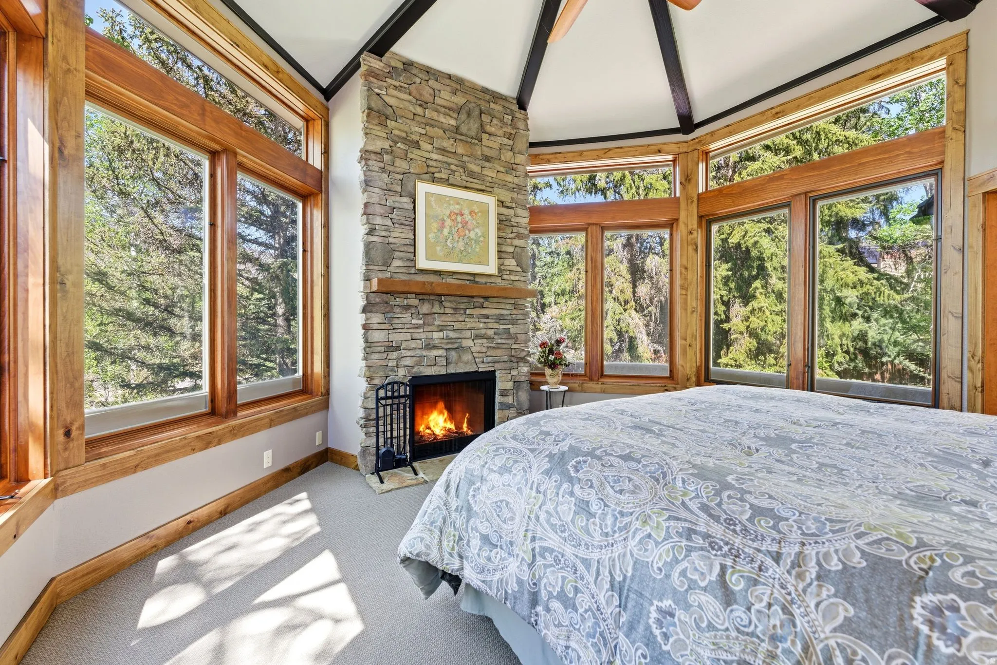 Stone-clad fireplace with a wood mantel