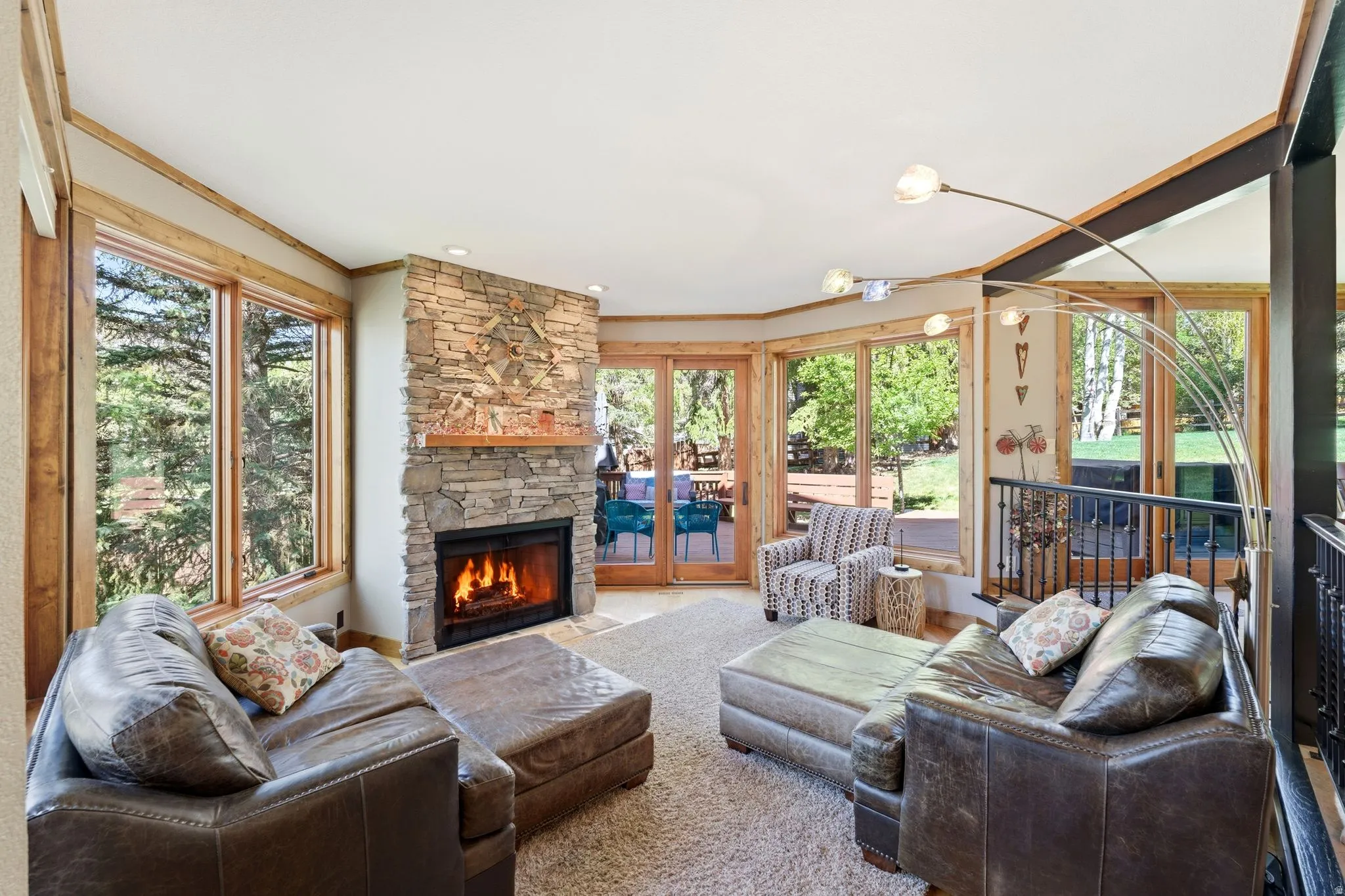 Living area with a stone-clad fireplace and wood mantle