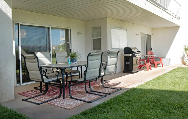 Ground-level patio featuring a concrete slab, sliding glass door entry, and an overhead soffit