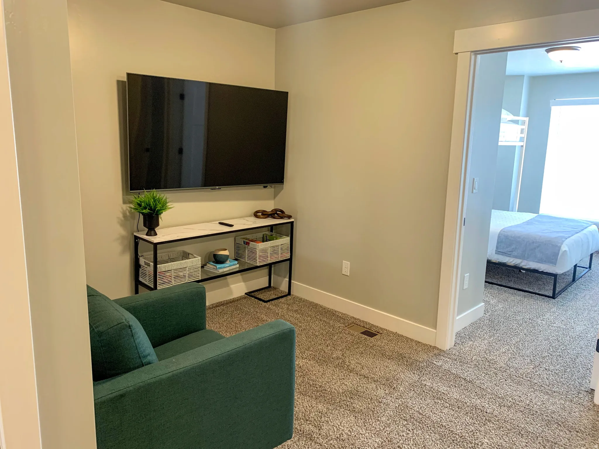 Wall-mounted television with a console featuring a marble-finish top