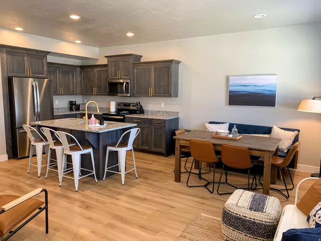 Open-concept kitchen and dining area featuring wood-finish flooring