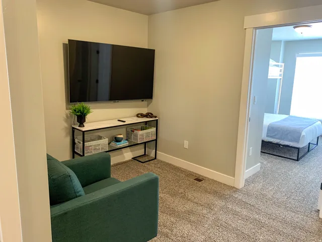 Wall-mounted television with a console featuring a marble-finish top