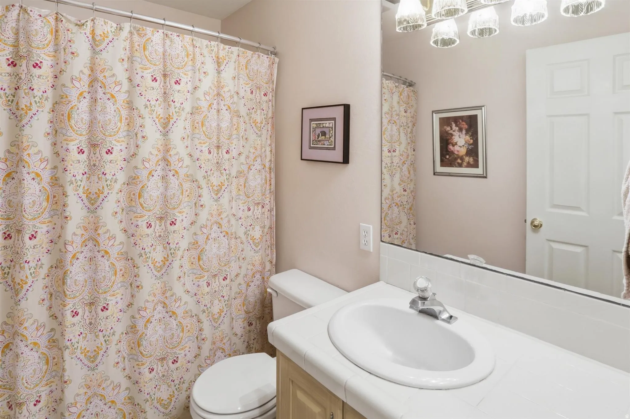 Main Bathroom vanity with an integrated sink, tile countertop, and polished chrome faucet