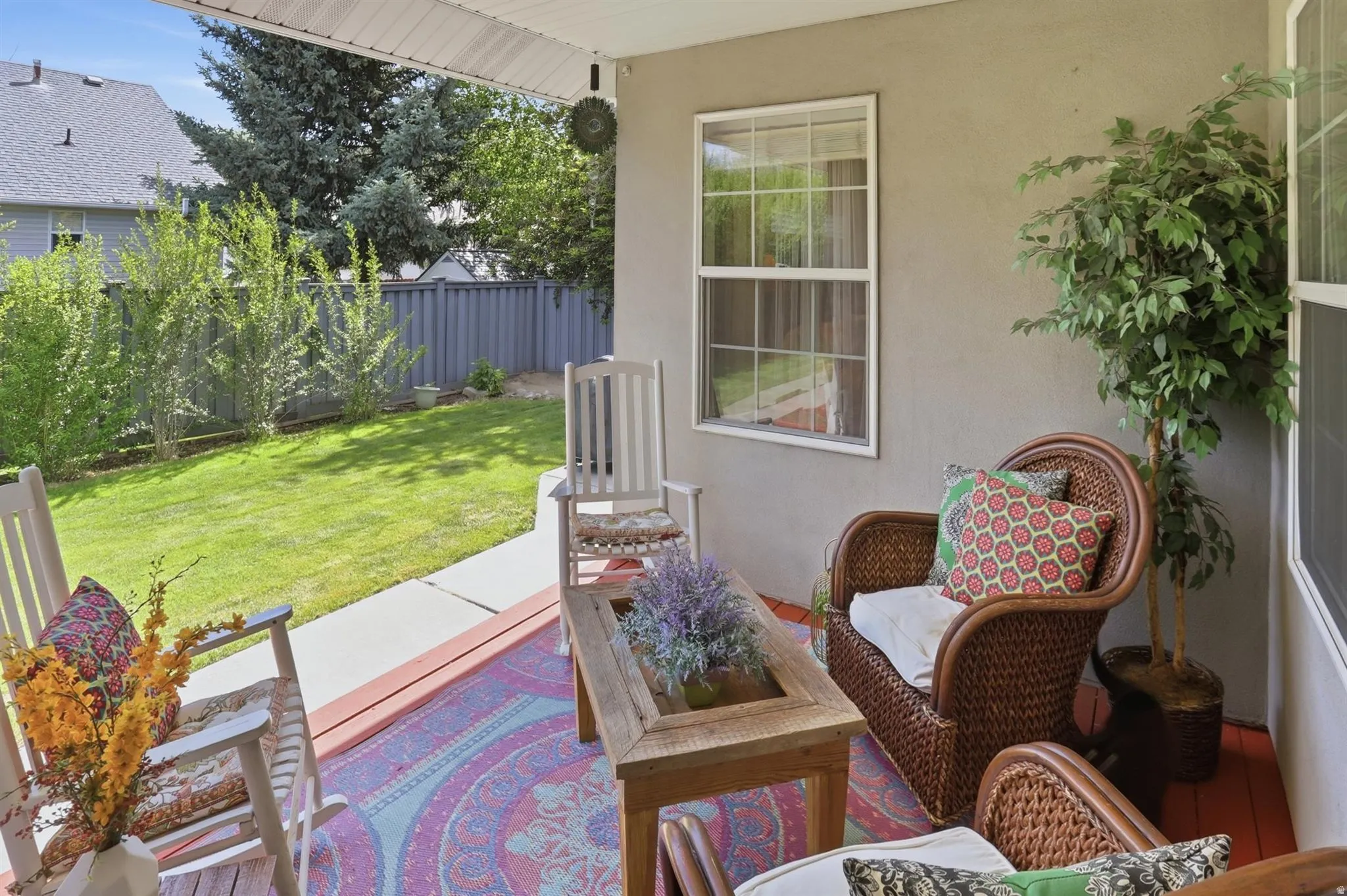 Covered deck featuring a painted wood floor and an exterior wall with a window