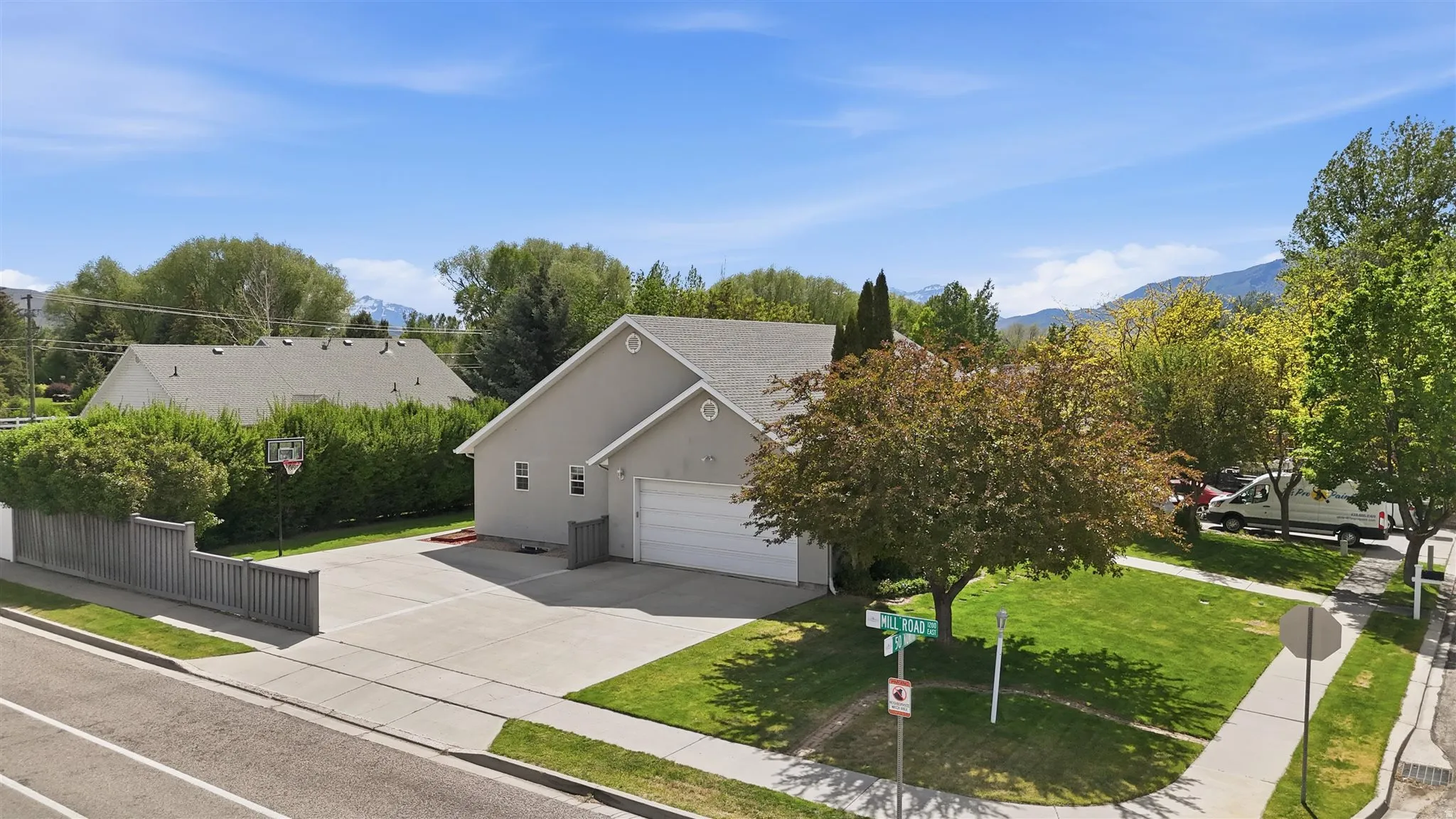 Stucco exterior home with an attached two-car garage and additional parking