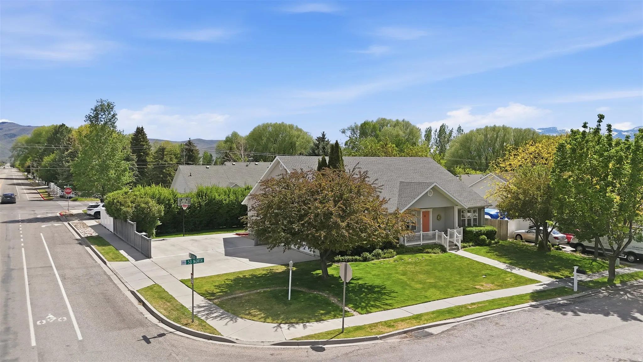 Rambler style residence featuring a gabled roof and light gray siding