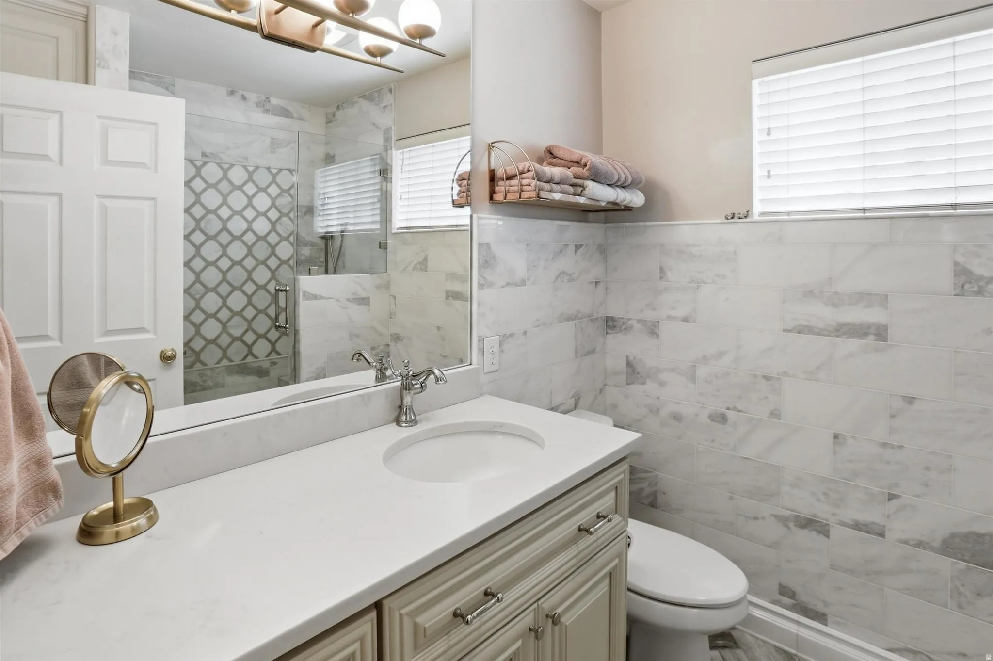 Bathroom vanity featuring a single integrated sink, light-toned countertop, and cabinet storage