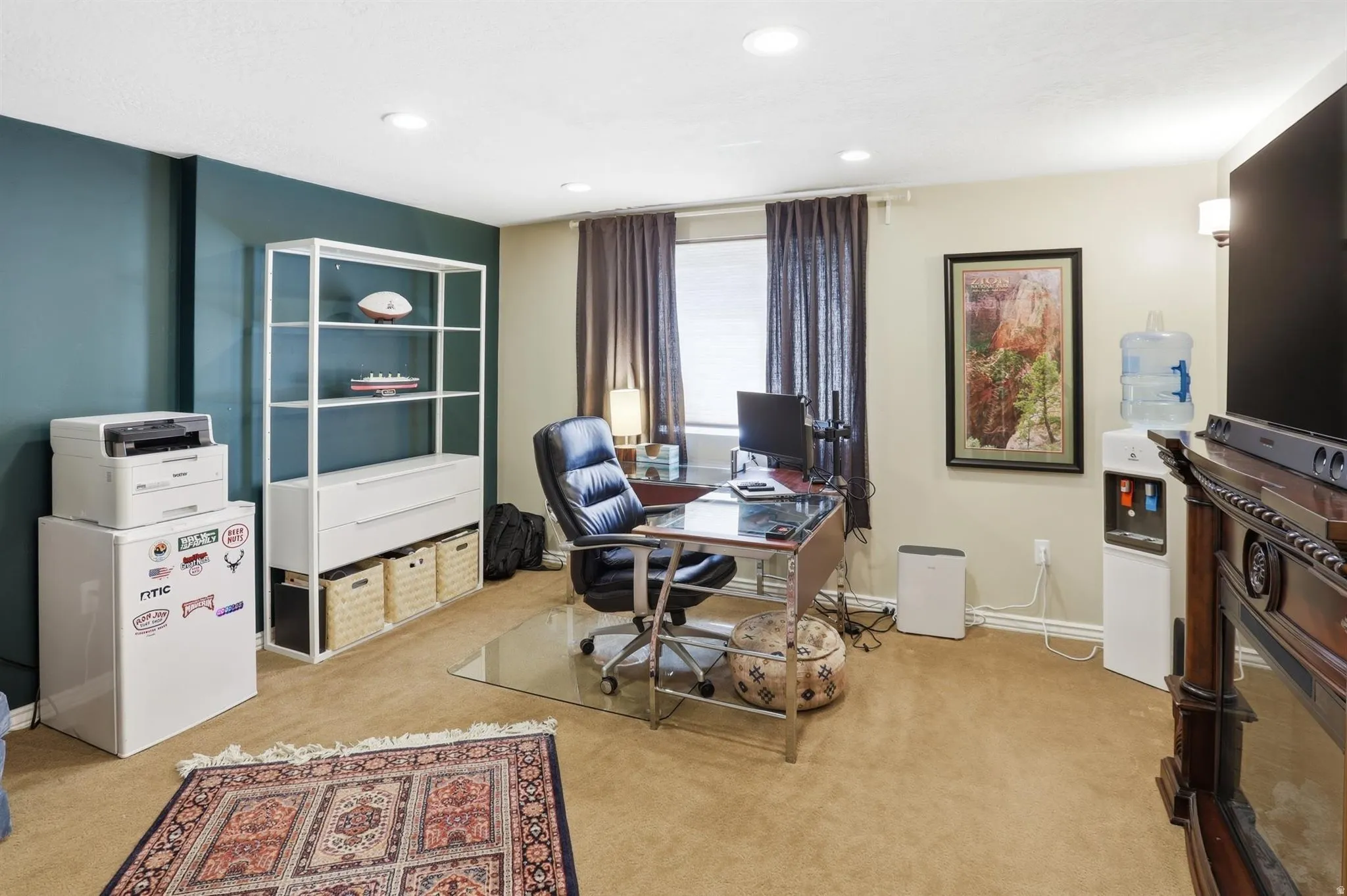 Carpeted room featuring a window with dark drapery, recessed lighting