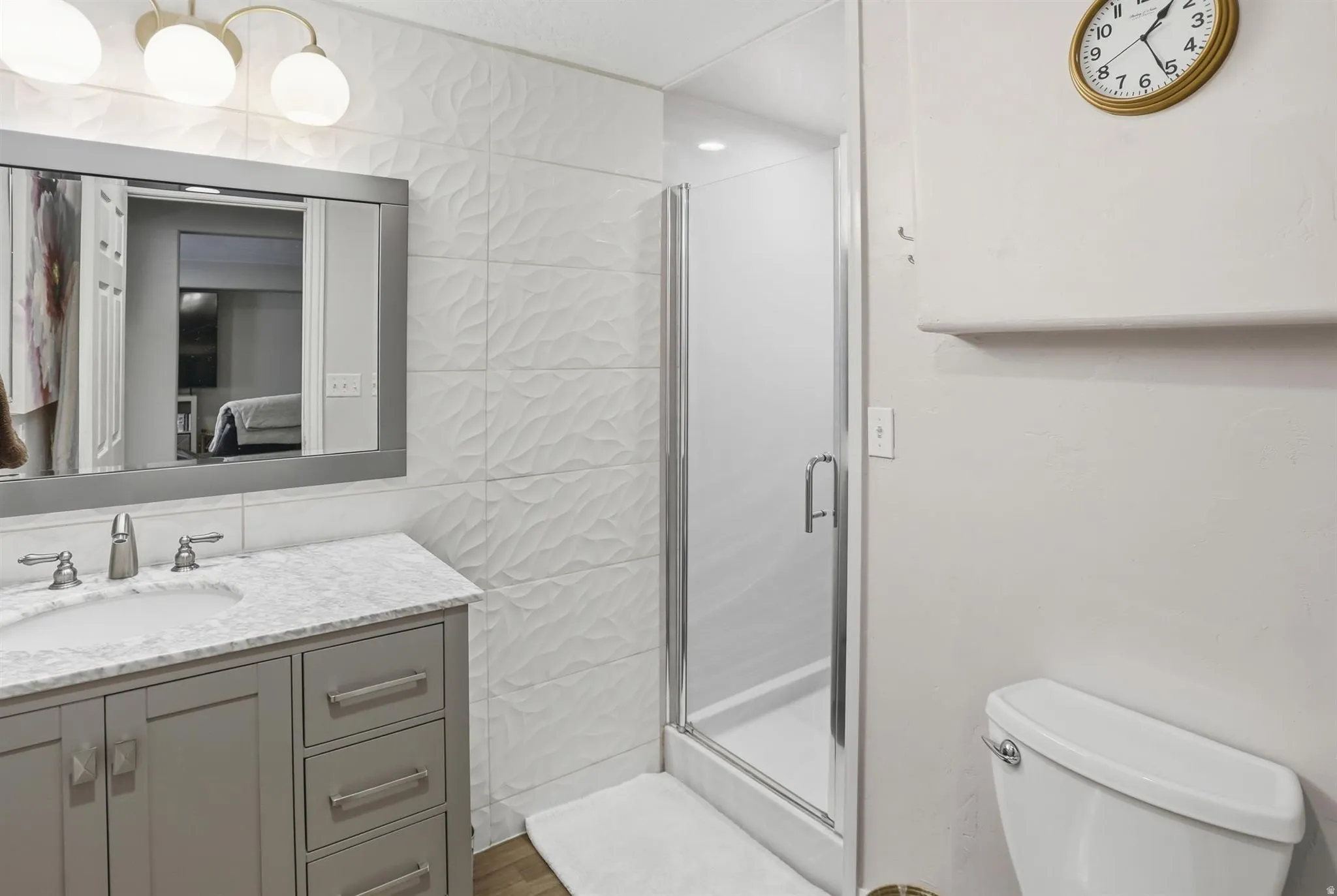 Modern bathroom vanity with a light gray cabinet and a light-colored countertop