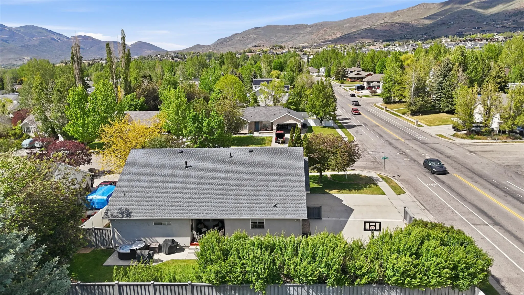 Rear exterior featuring a patio, fenced yard, and mature landscaping