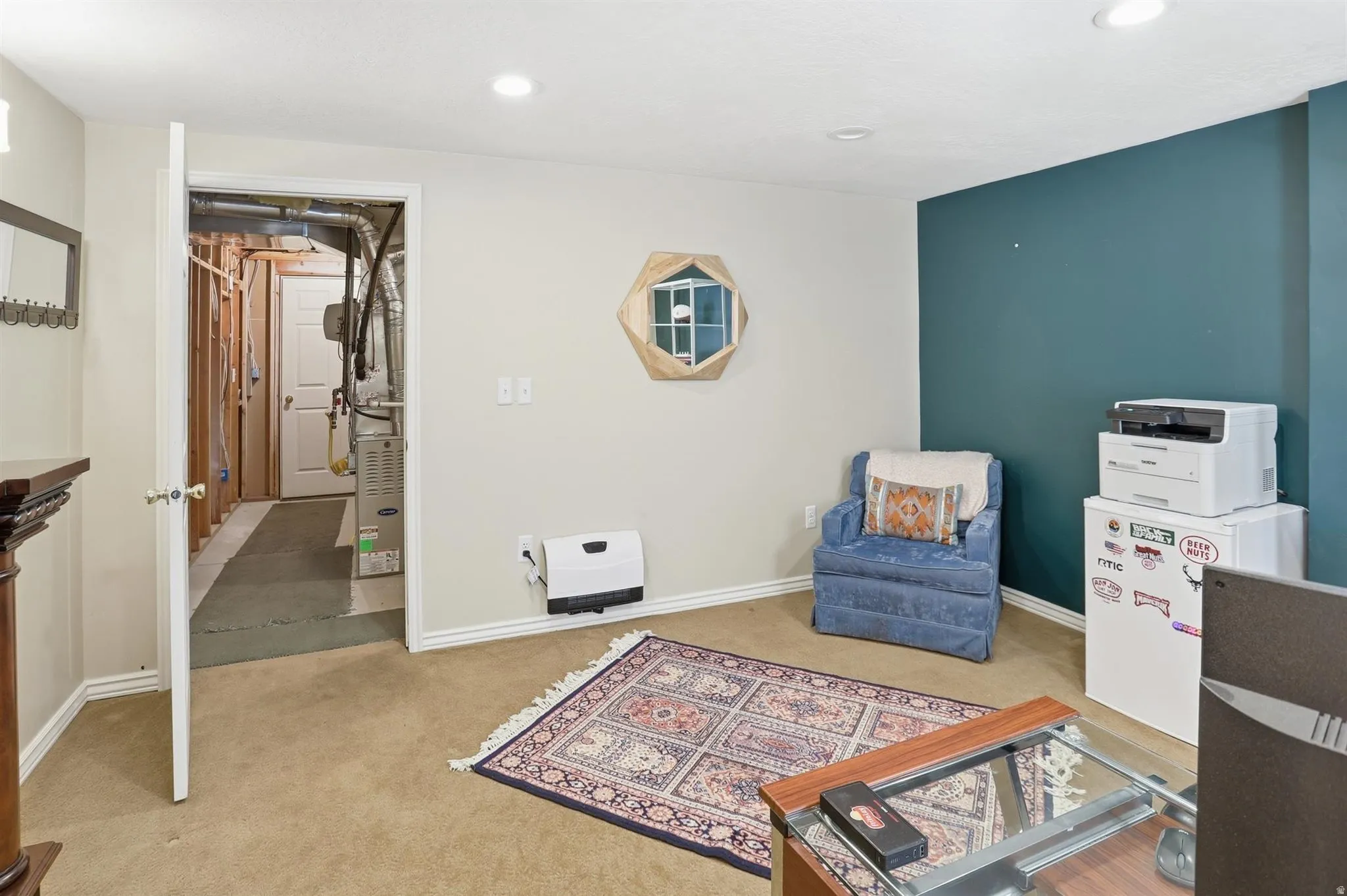 Carpeted room featuring a recessed lighting, a white painted door frame, and a contrasting accent wall