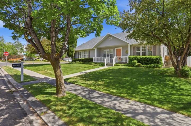 Gray-sided residence with white trim and a contrasting orange front door