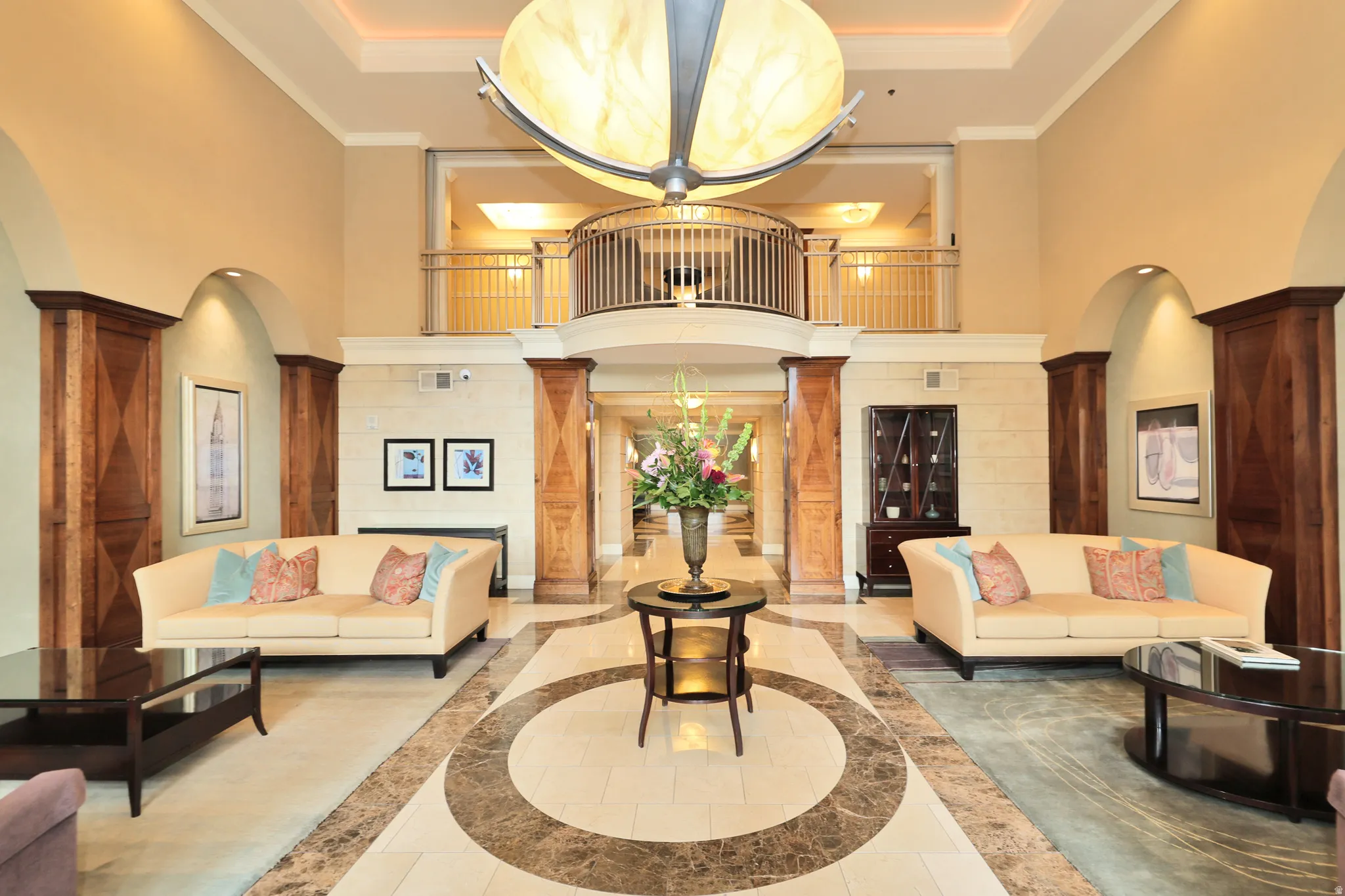 Grand two-story lobby featuring a large central chandelier