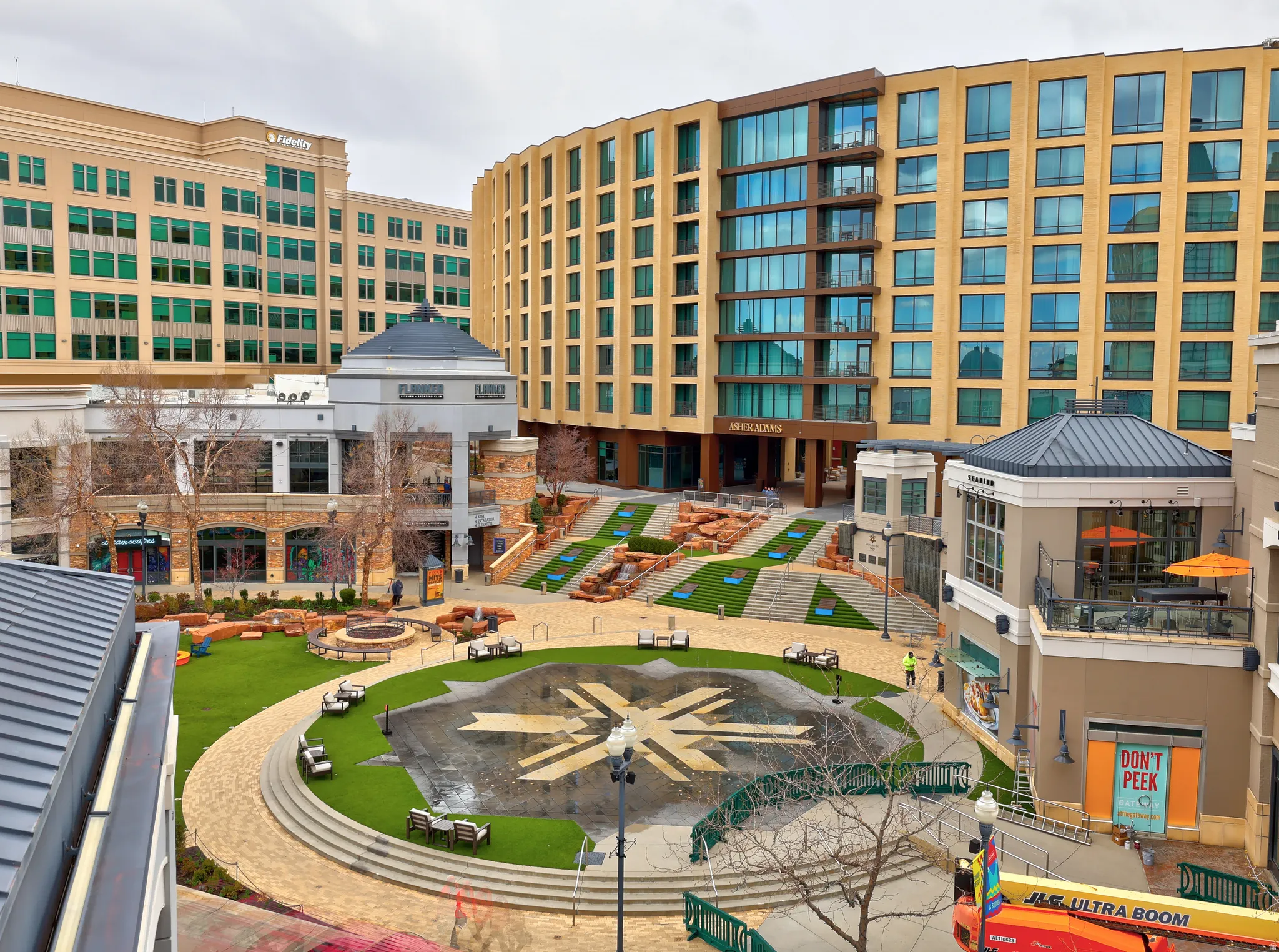 Landscaped courtyard featuring a central lawn area, decorative paving, and terraced green spaces