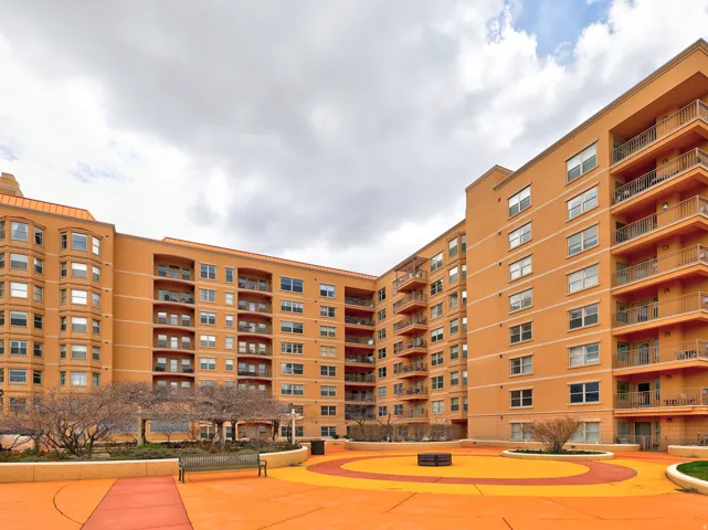 Multi-story building featuring a stucco exterior with multiple balconies and bay windows