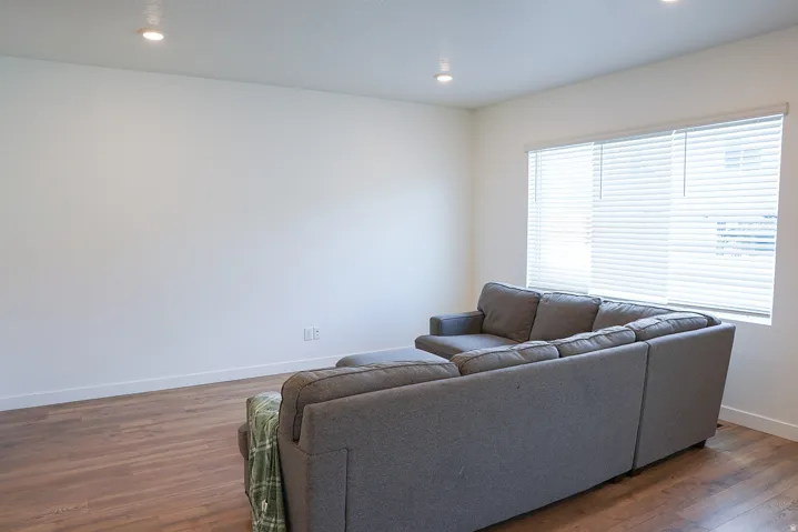 Living space featuring wood-finish flooring, recessed lighting, and ample natural light from multiple windows