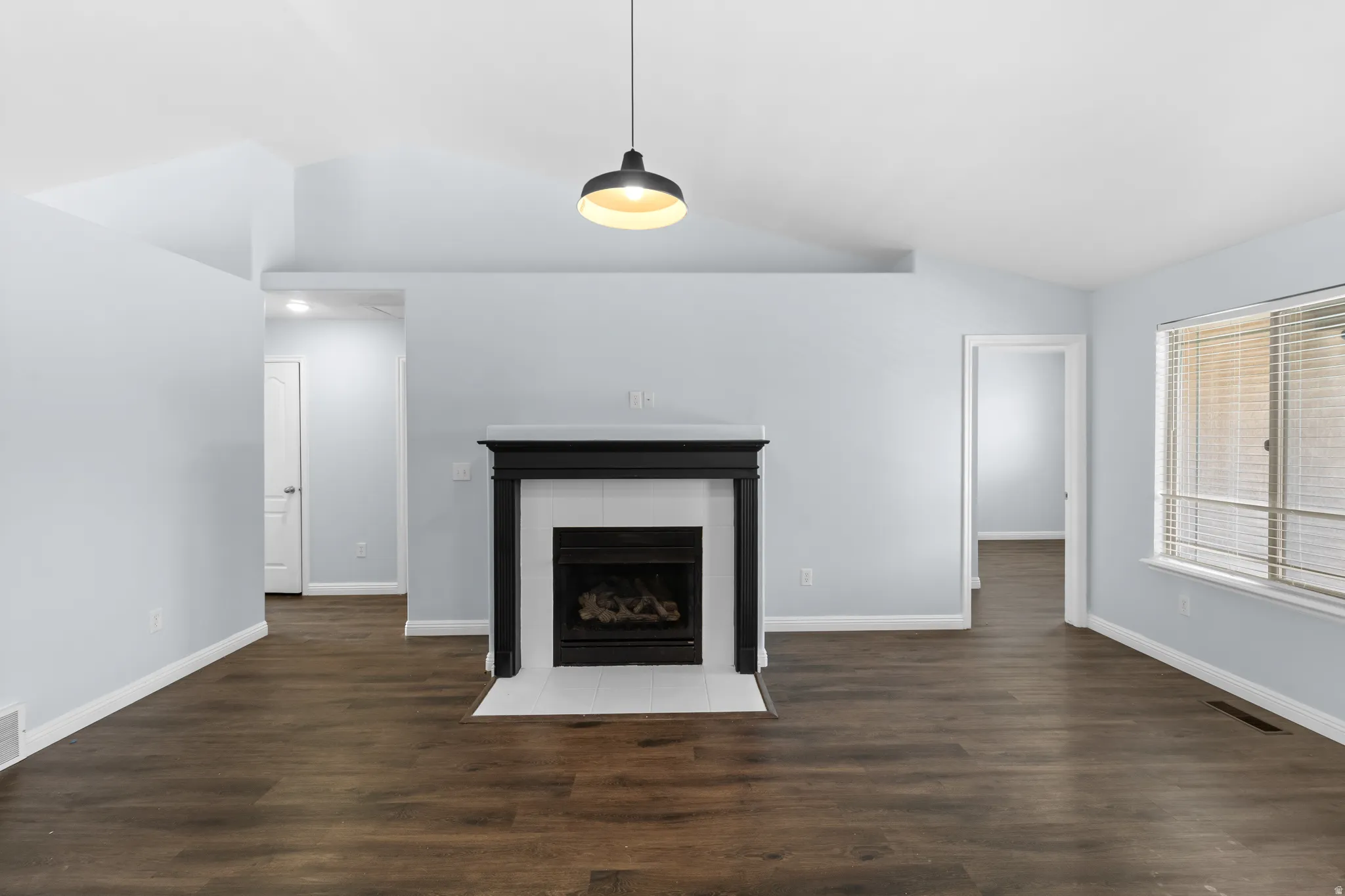 Central fireplace with a black mantel and white tile hearth