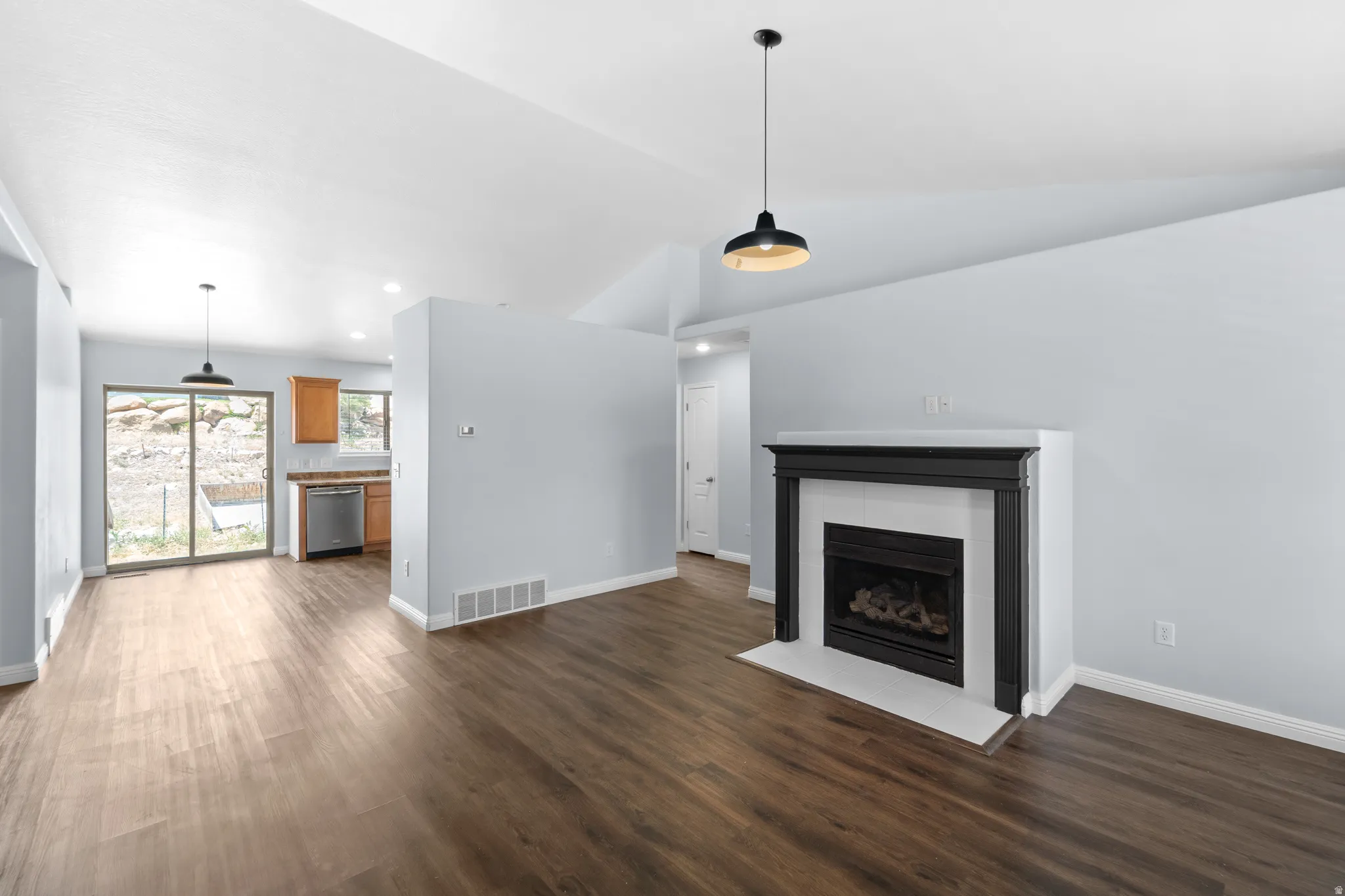 Contemporary fireplace with a black mantel and white surround, set against light blue walls