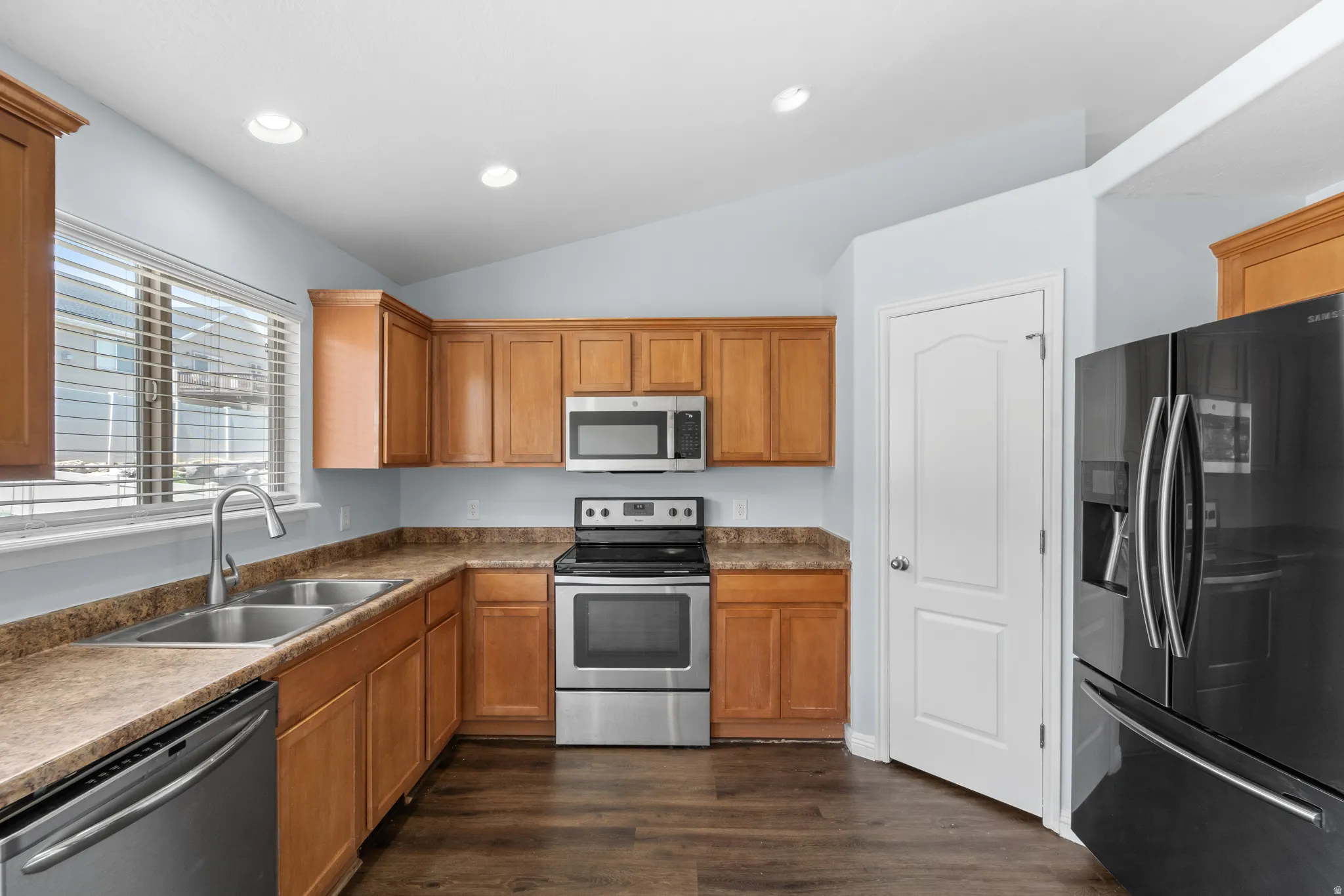 Kitchen featuring wood-finish cabinetry and stainless steel appliances