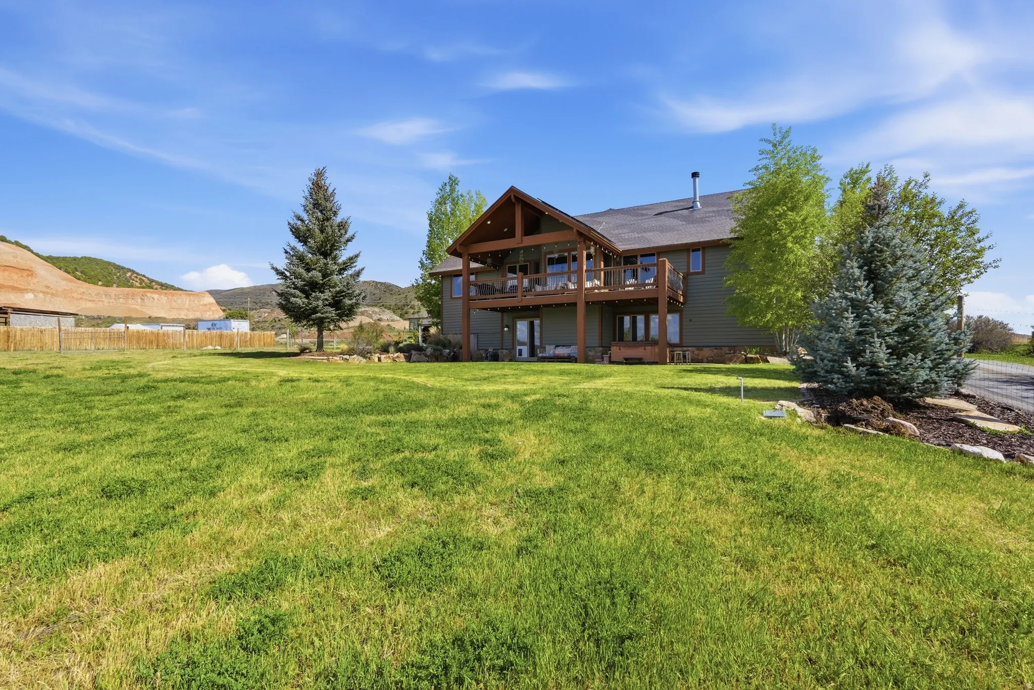 Expansive green lawn with mature landscaping