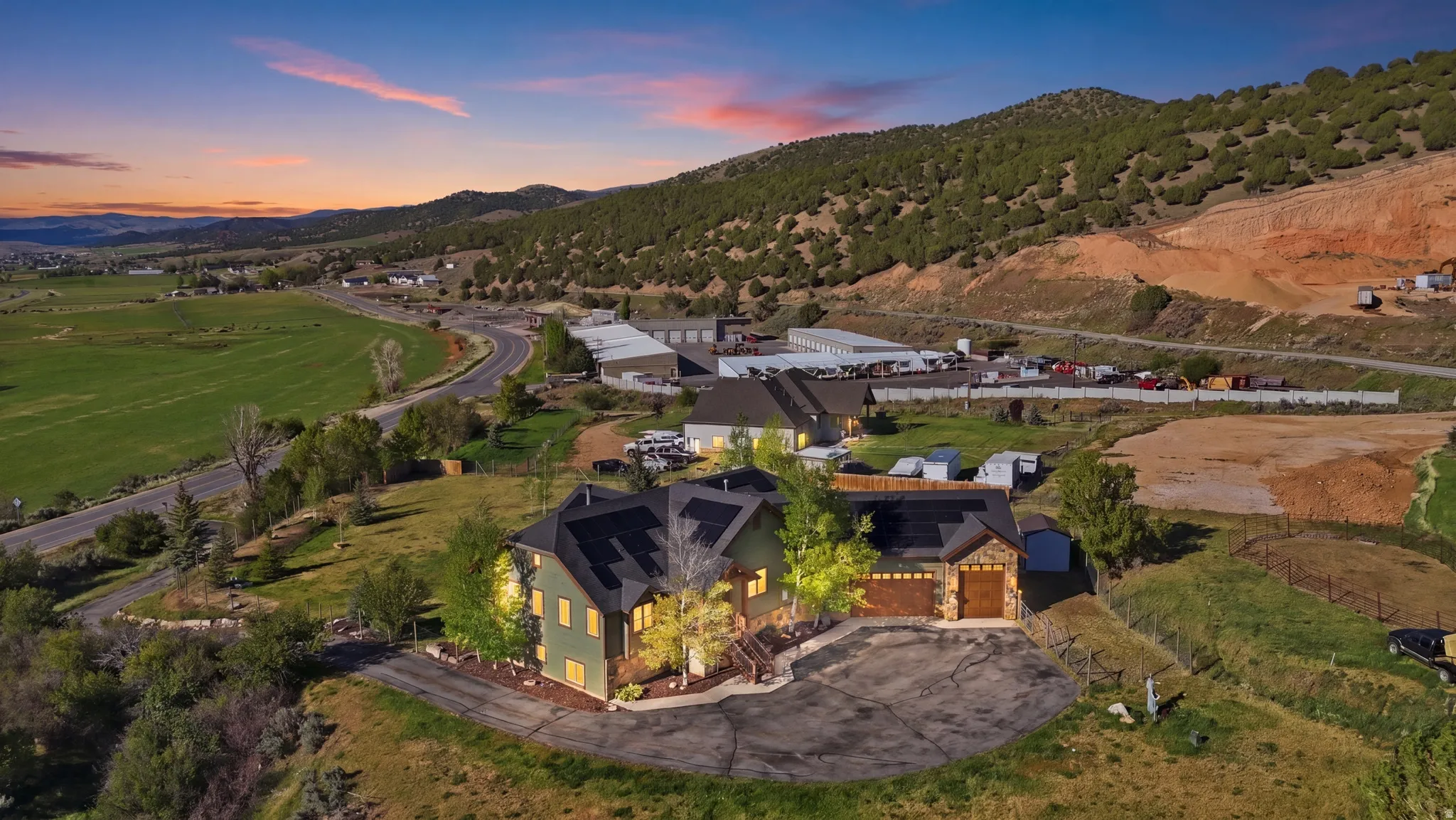 Two-story residence featuring a green facade and stone accents