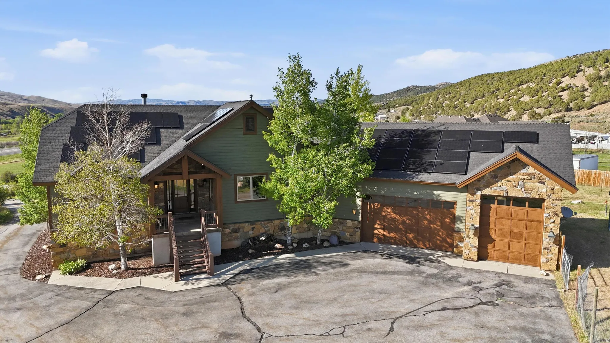 Craftsman-style home featuring a stone and siding exterior