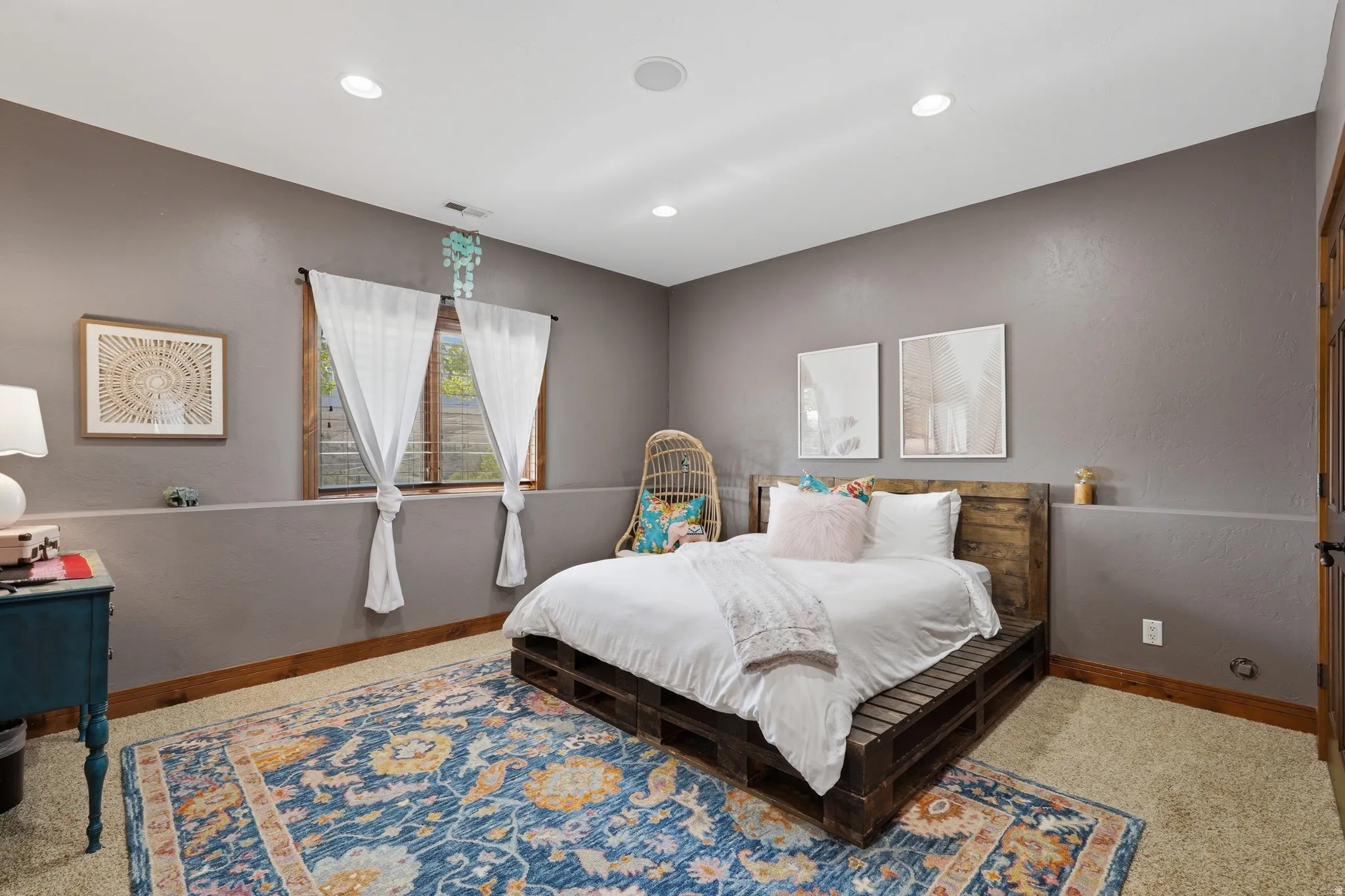 Spacious room featuring carpeting, recessed lighting, and a window with wood trim