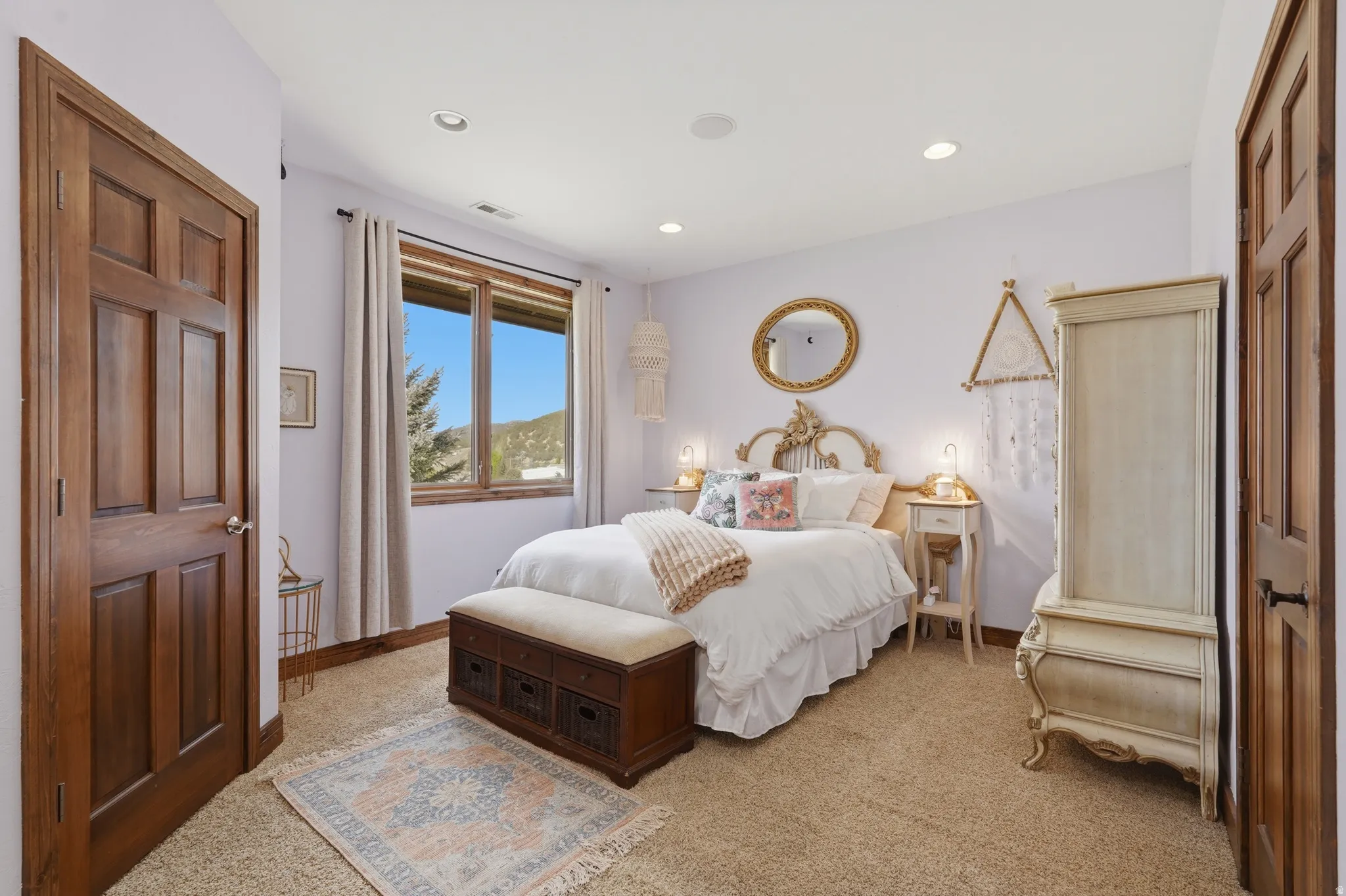 Carpeted room with recessed lighting and a window featuring natural wood trim