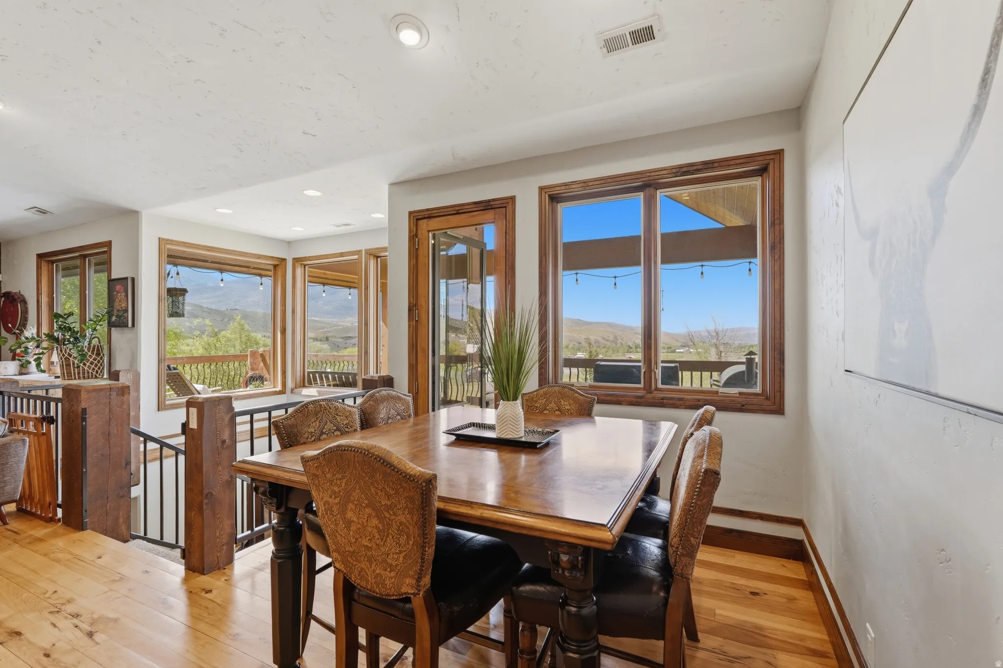 Dining area featuring wood-finish flooring and multiple windows with wood trim