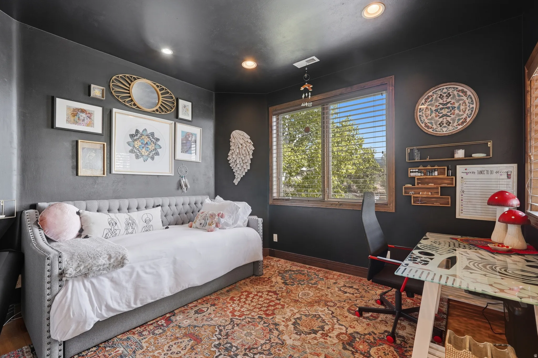 Spacious room featuring dark wall finishes, a large window with horizontal blinds, and recessed lighting