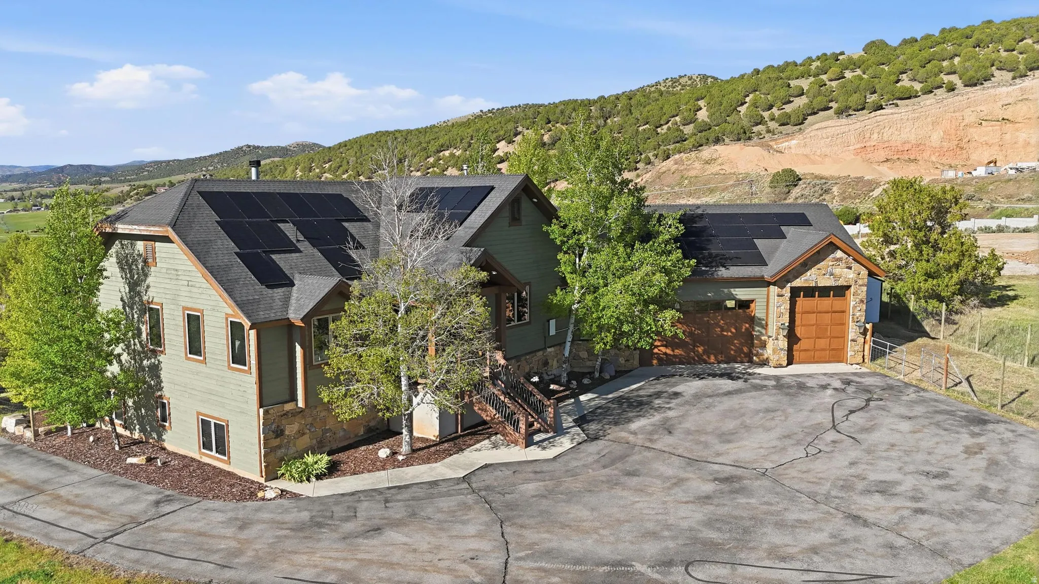 Contemporary exterior featuring stone accents and light green siding