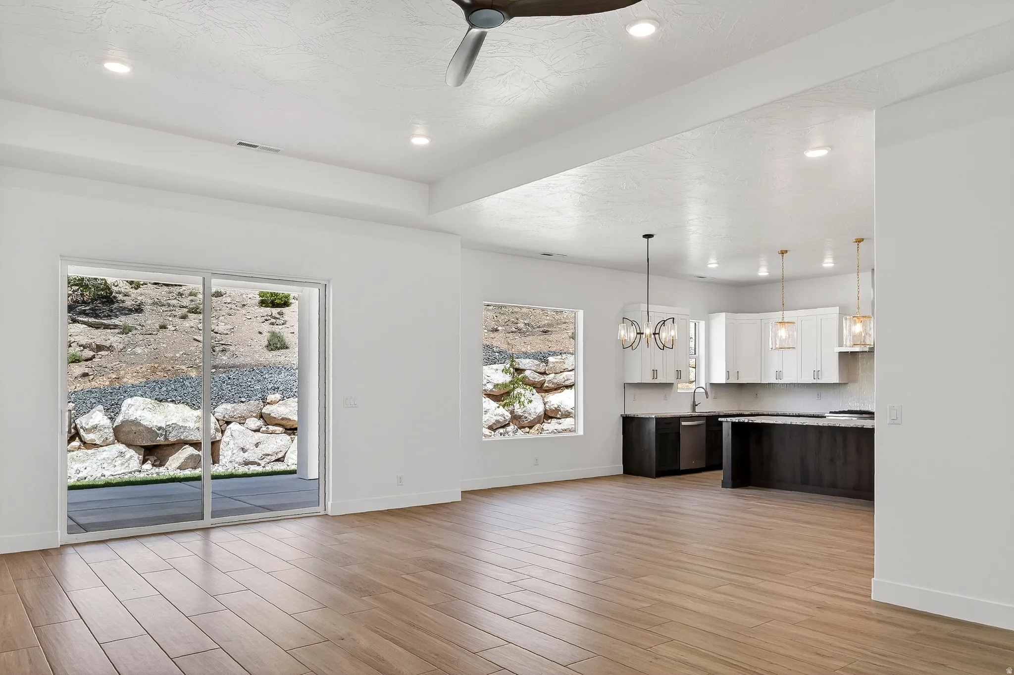 Open-concept living space featuring wood-finish flooring, recessed lighting, and a modern ceiling fan