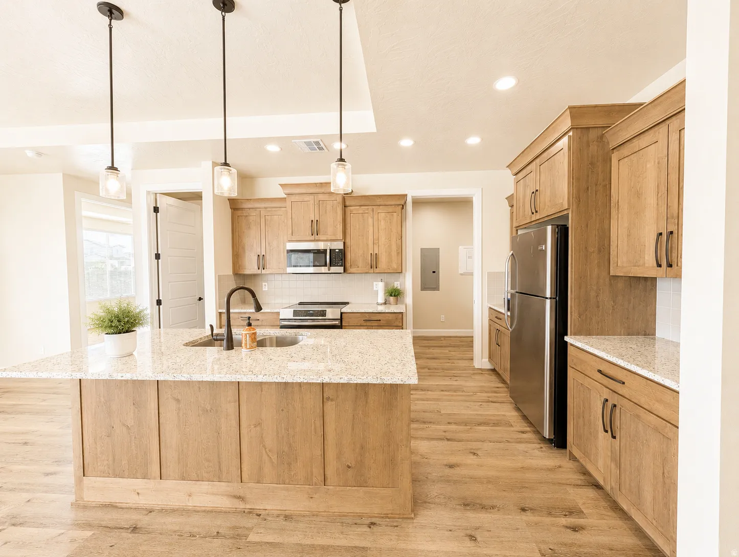 Kitchen featuring a large island with a granite countertop and integrated sink