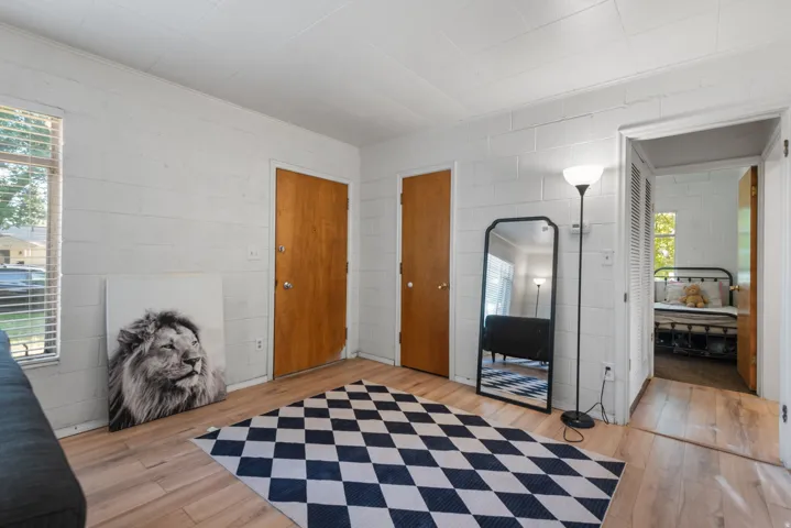 Light wood-finish flooring complements the white painted block walls