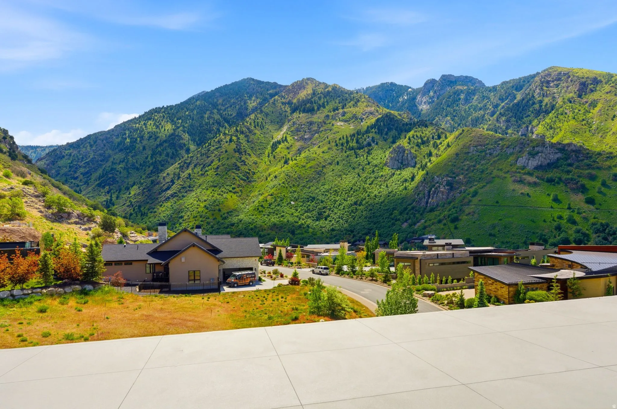 Mountainous landscape with lush green foliage and scattered rock formations