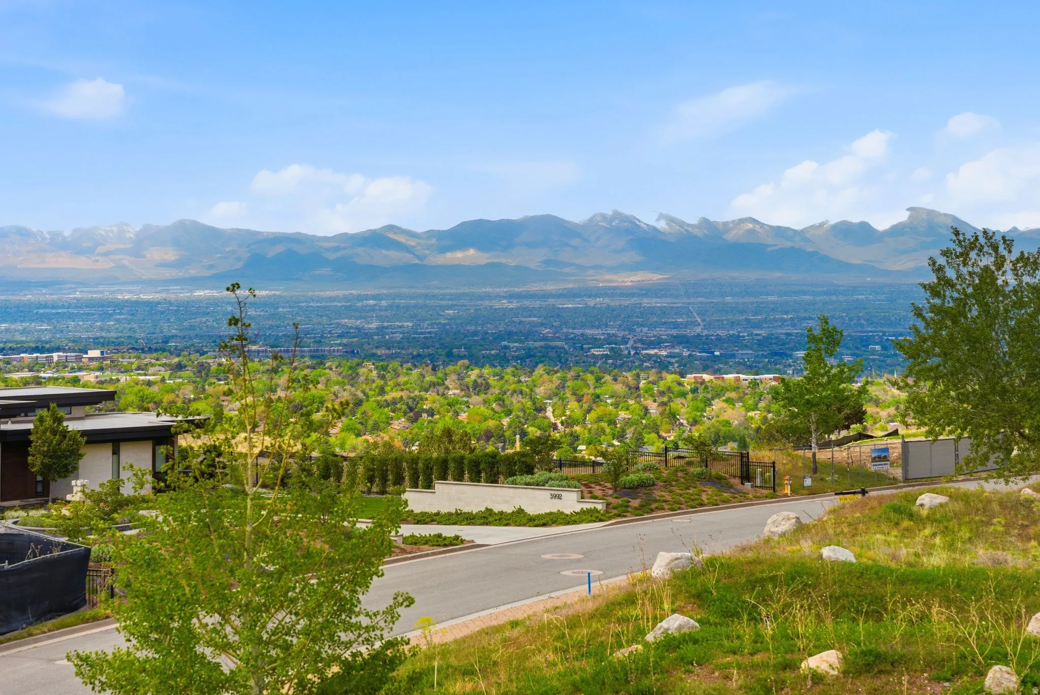 Panoramic mountain and city landscape with a modern-style residence featuring a flat roofline