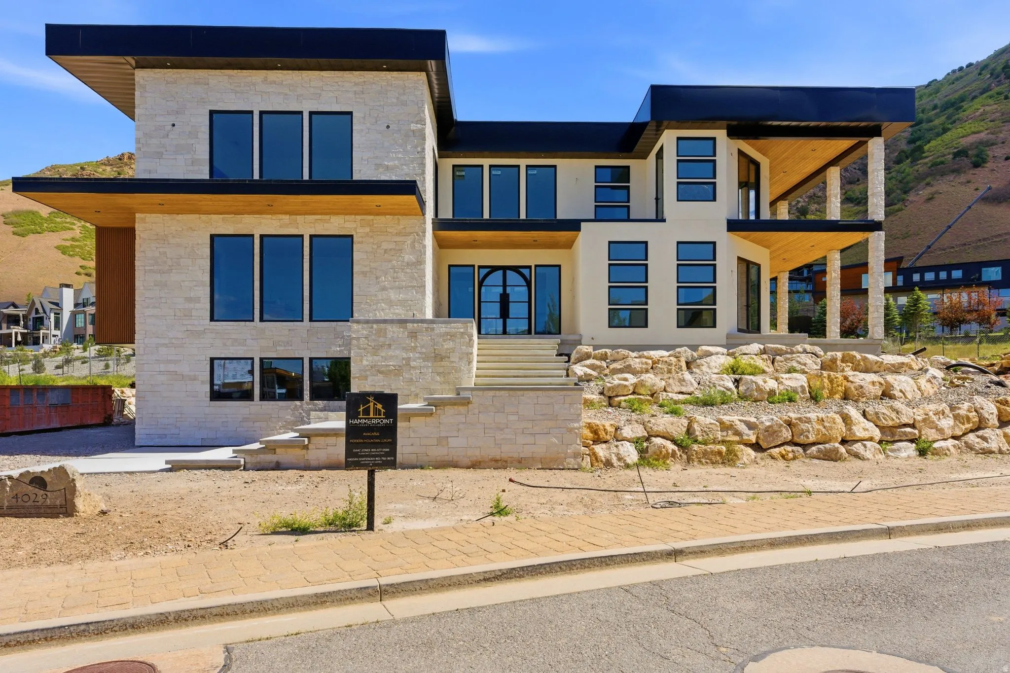Contemporary architectural design featuring stone facade accents and a flat roofline