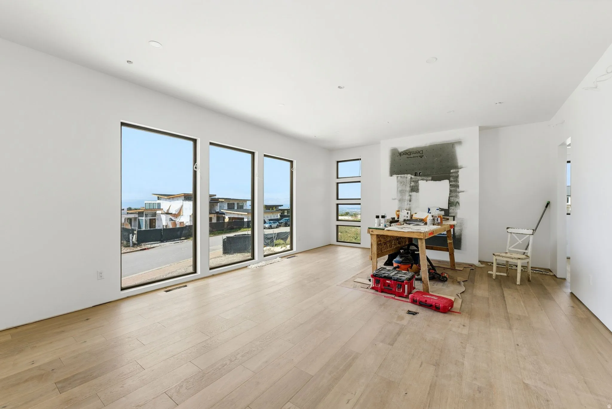 Spacious interior featuring light wood-finish flooring, recessed lighting, and white walls
