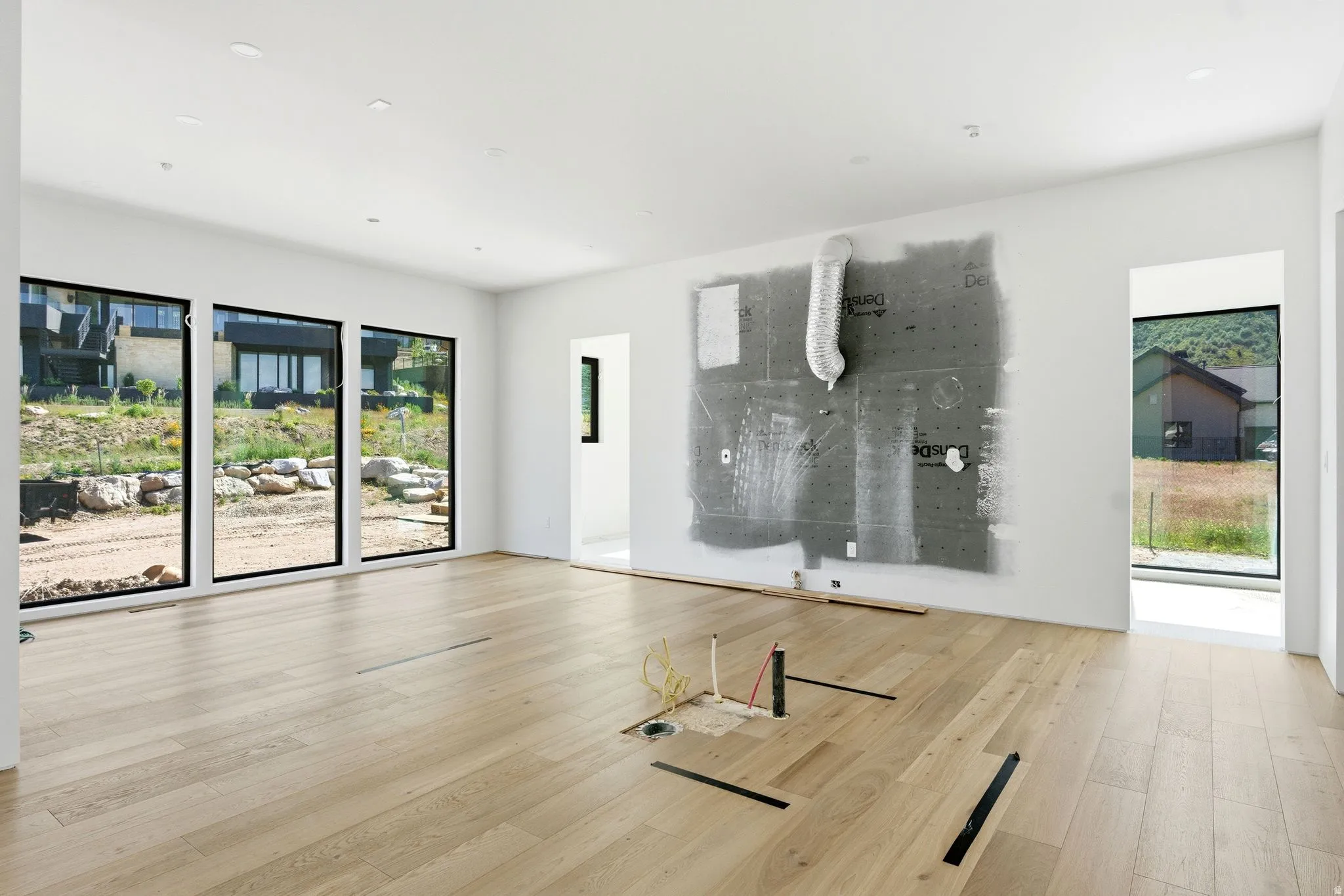 Open-concept room featuring light wood-finish flooring, white walls, and recessed ceiling lighting