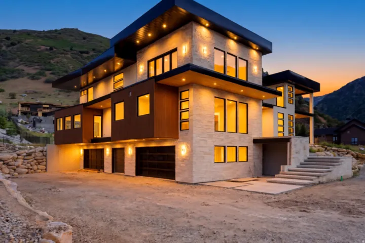 Contemporary multi-level exterior featuring stacked stone and wood-finish siding