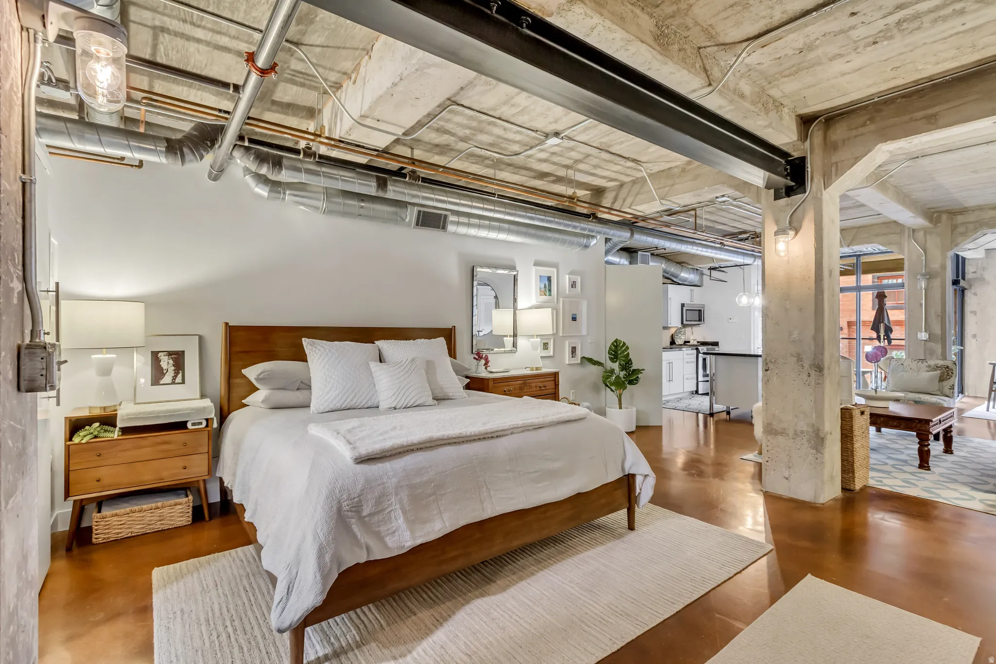Open-concept interior featuring concrete ceilings with exposed ductwork, concrete columns, and polished concrete flooring