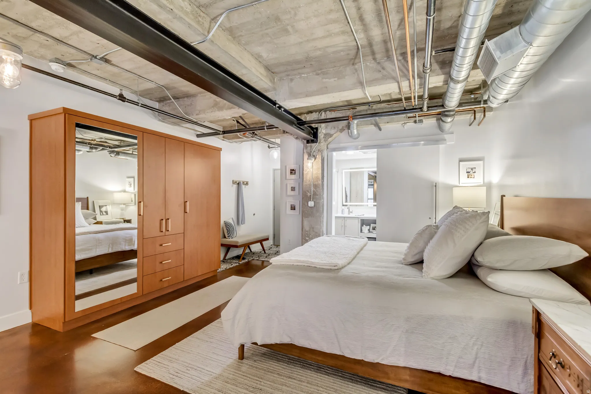 Industrial-style concrete ceiling featuring exposed ductwork and structural beams