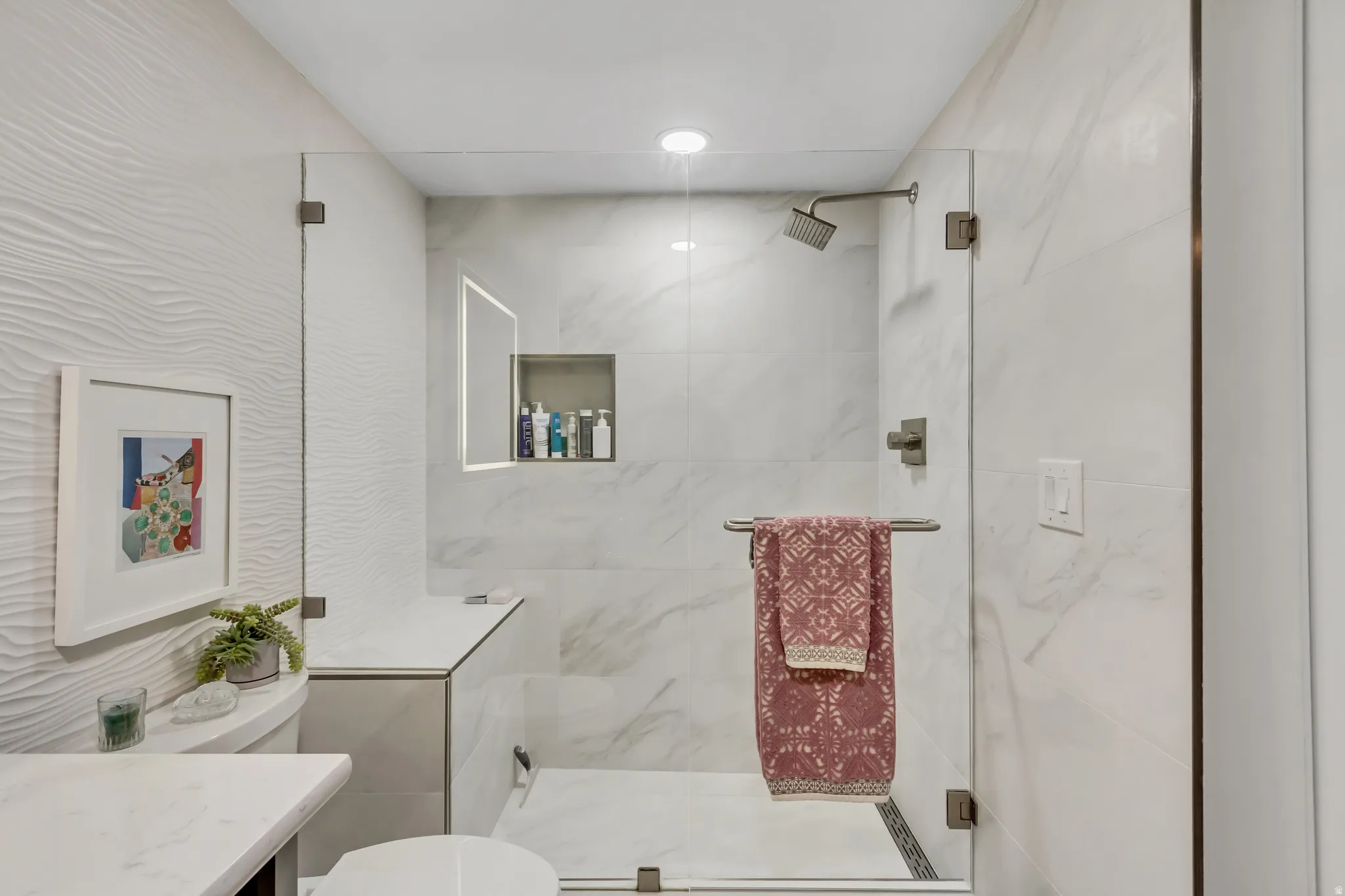 Modern shower enclosure with clear glass panels and brushed nickel hardware