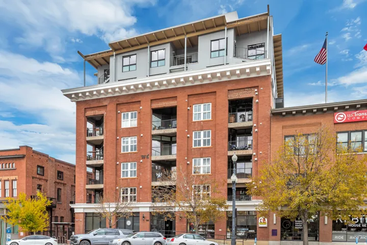 Red brick facade building featuring a white cornice and integrated balconies