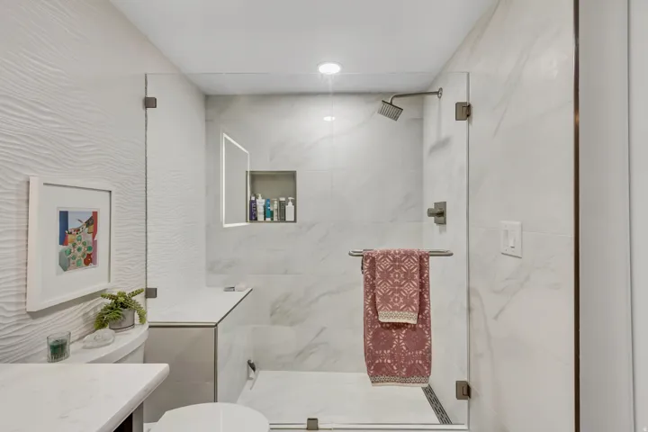 Modern shower enclosure with clear glass panels and brushed nickel hardware