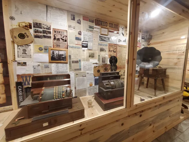 Custom display case featuring clear glass panels and natural wood-finish framing