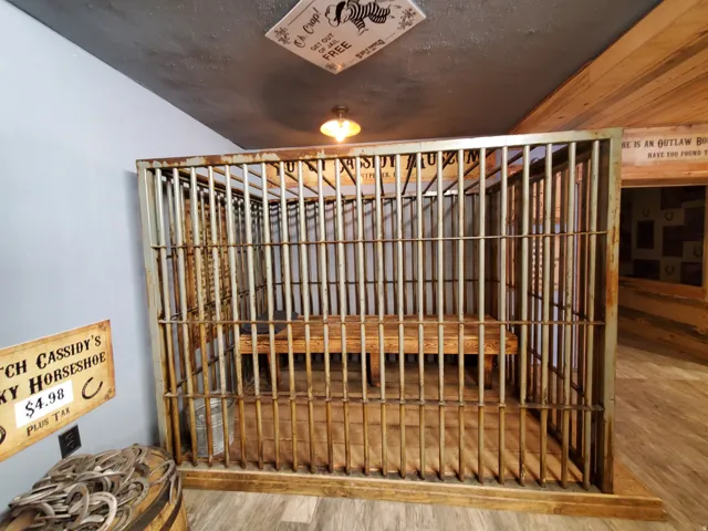 Custom-built metal cage structure featuring a built-in wood-plank bench