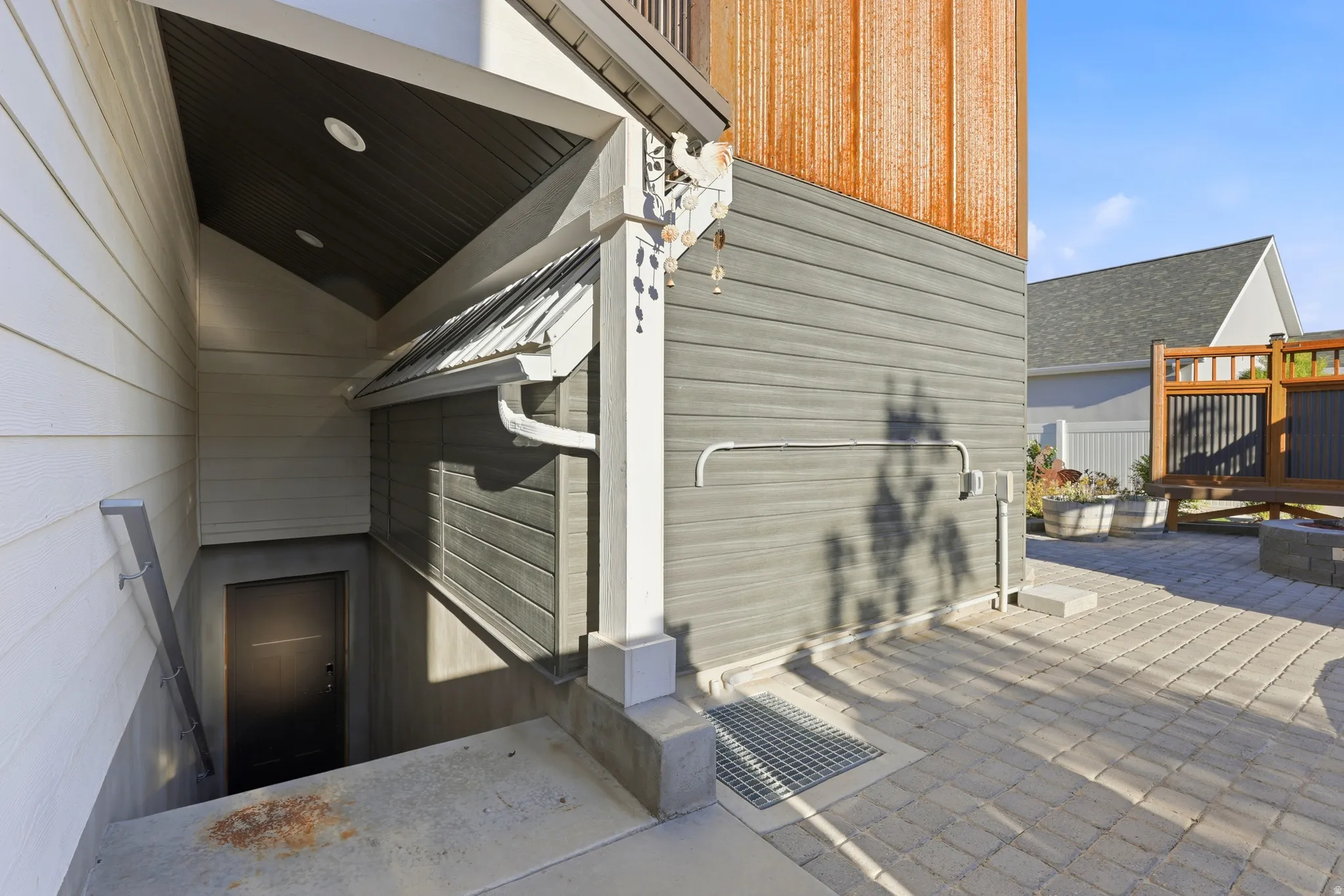 Exterior showcasing a multi-textured facade with vertical wood siding and horizontal grey siding