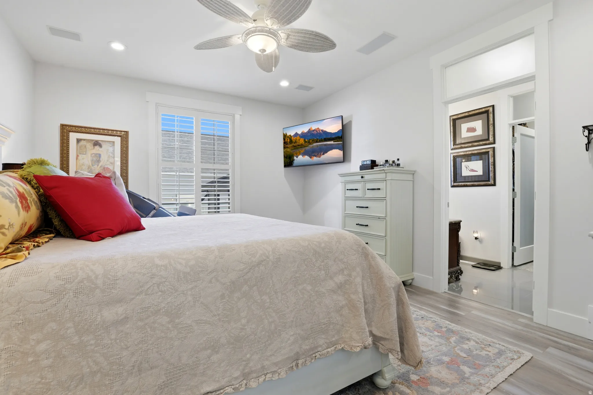 Spacious interior featuring light wood-finish flooring, recessed lighting, and a ceiling fan with integrated light